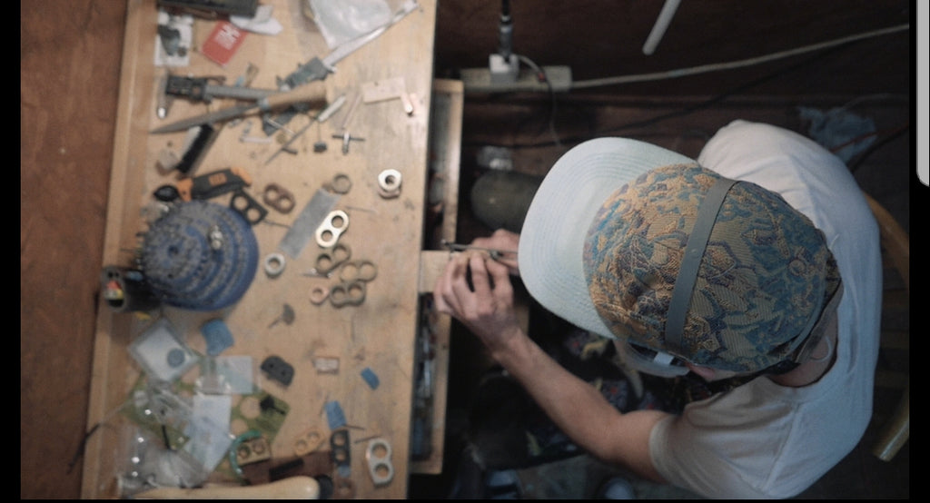 Benjamin Posin, founder of Sticks & Stones Jewelry, working on a new piece in his workshop