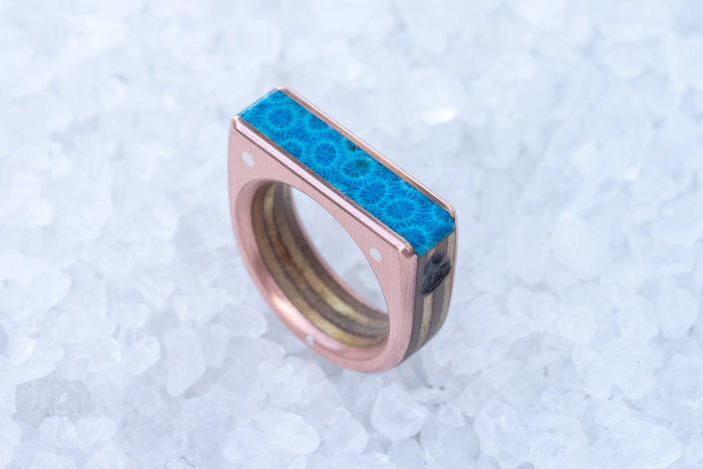 Wooden ring with blue fossilized coral top and copper sides